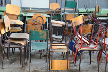 Old thrown school chairs