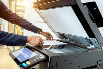 Bussiness man Hand press button on panel of printer, printer scanner laser office copy machine...