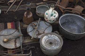 copper kitchenware on the ground. old local copper materials in the junk shop.