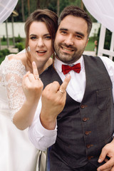 Happy bride and groom on the wheelchair show their wedding rings