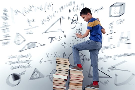Composite image of schoolboy climbing stack of book