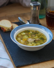 soup  with vegetables and chicken (a portion in a plate) - natural food. food background