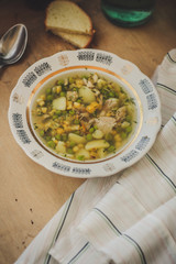 soup  with vegetables and chicken (a portion in a plate) - natural food. food background