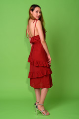 Young beautiful Asian woman against green background