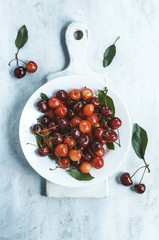 Sweet cherry on the grunge white cutting board background. Rustic style