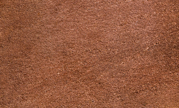 Brown sandstone wall texture details. Close-up photo of gritty background. Horizontal orientation