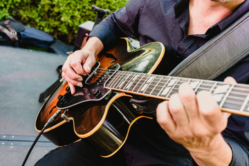 Guitarist playing his guitar outdoors