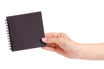 Notepad with black paper in hand on white background isolation