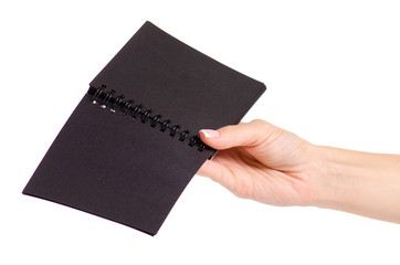 Notepad with black paper in hand on white background isolation