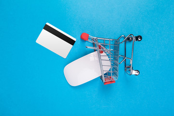 Toy shopping cart  on blue background top view - Powered by Adobe