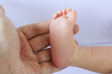 Closeup Newborn Baby Foot 2 Weeks Old In Mother's Hand
