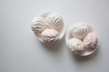 Two bowls with zefir dessert isolated on white background from a high angle view with copy space