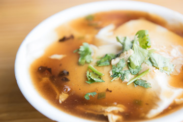 Jellied bean curd and cilantro leaves. Tofu pudding. Unique Traditional Chinese Foods