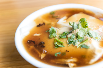 Jellied bean curd and cilantro leaves. Tofu pudding. Unique Traditional Chinese Foods