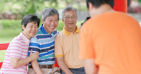 Son taking photo on his parent and friends