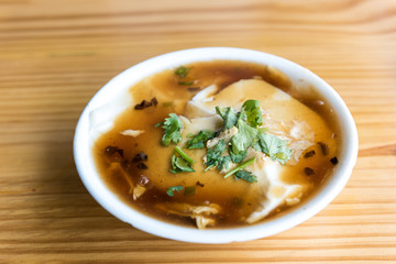 Jellied bean curd and cilantro leaves. Tofu pudding. Unique Traditional Chinese Foods