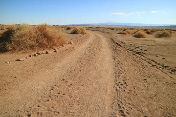 Fototapeta na wymiar Desert road in the archaeological site of Aldea de Tulor, Atacama Desert in Northern Chile 