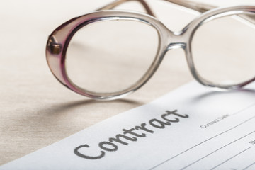 Close up shot of Eyeglasses  on contract document papers business concept