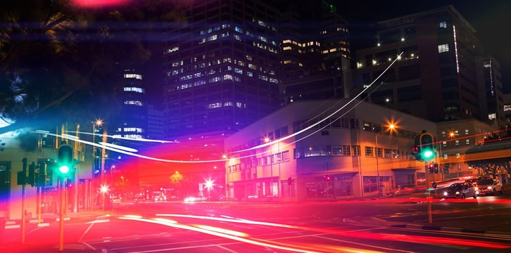 illuminated roads by building in city