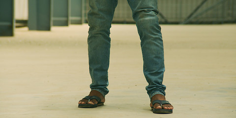 Feet of a man wearing sandals