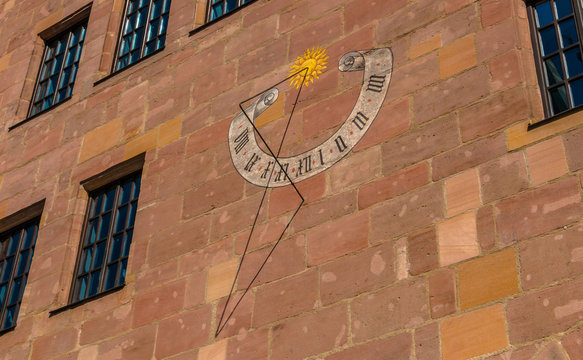 Medieval sundial on the house wall in old town of Nuremberg, Germany. Sights of Bavaria.