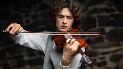 young guy playing the violin