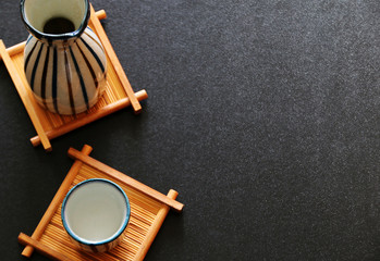 sake japanese oriental drink style on Bamboo table Top view