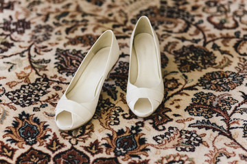 Wedding shoes on their wedding isolated in a room