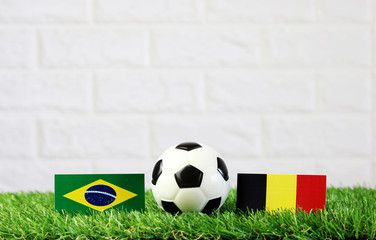 Top view ball with Brazil VS Belgium flag match on Green grass football 2018