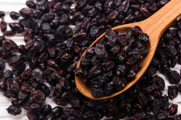 dried barberry berries on the rustic background