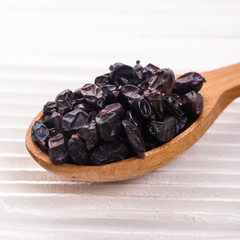 dried barberry berries on the rustic background
