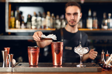 Bartender Making Cocktail. Barman Putting Ice In Glass