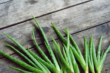 Aloe vera on wooden table background, copy space, skin care concept