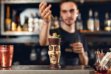 Fototapeta na wymiar Preparing Cocktails. Bartender Making Cocktail In Bar