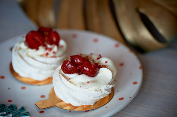 Air and delicious meringue Anna Pavlova in the heart of the plate. Culinary art