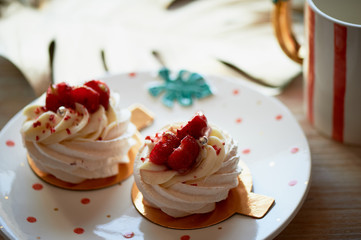 Air and delicious meringue Anna Pavlova in the heart of the plate. Culinary art