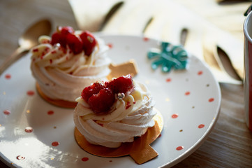 Air and delicious meringue Anna Pavlova in the heart of the plate. Culinary art