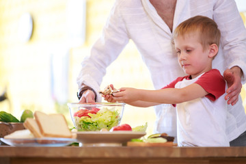 Photo of man and son preparing salad