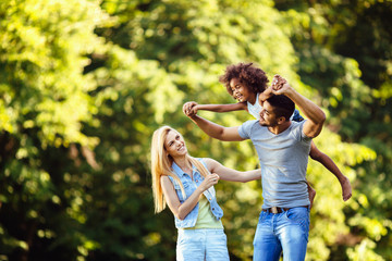 Picture of happy young couple spending time with their daughter