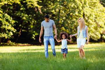 Fototapeta premium Happy young couple spending time with their daughter