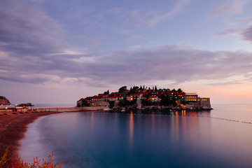 Fototapeta premium Sveti Stefan island in Montenegro, sunset on the seacoast. Popular travel destination.