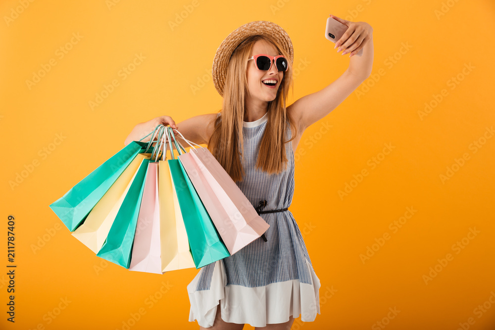 Canvas Prints Portrait of a cheerful young blonde woman in summer hat