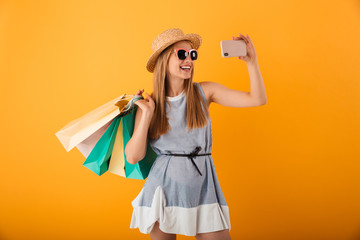 Portrait of a happy young blonde woman in summer hat