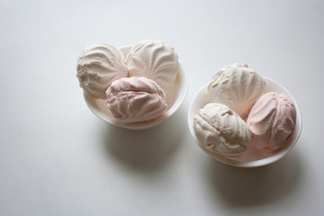 White and pink zephyr in ceramic bowls isolated in white background