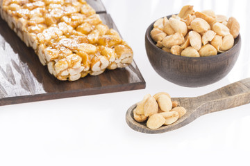 Bars with peanuts isolated close-up on white background.