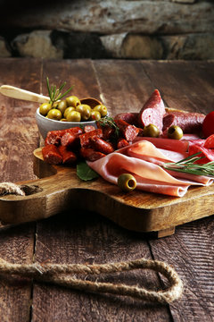 Marble cutting board with prosciutto, bacon, salami and sausages