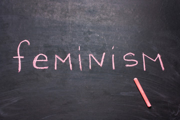The word feminism is written chalk .The concept of equality