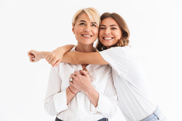 Portrait closeup of two attractive stylish women, young daughter hugging her beautiful mother,...