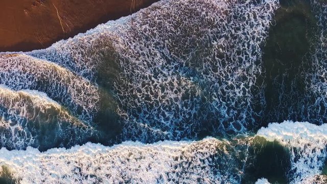Aerial view zooming out above beautiful morning surf in Eastern Australia. Drone shot - Coolum, Australia