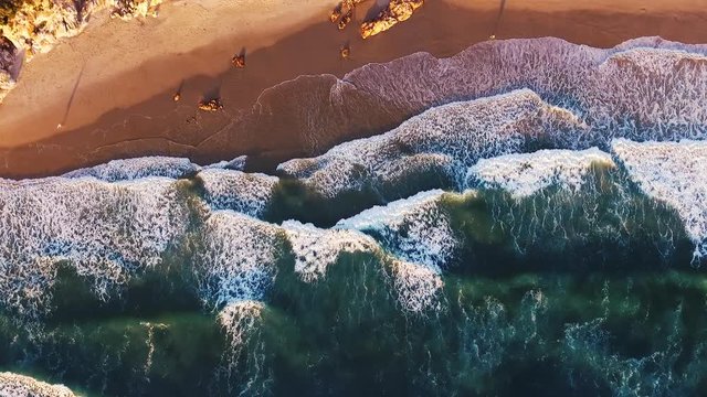 Aerial shot of waves breaking on East Coast of Australia. Sunrise. Drone shot. Coolum, Australia